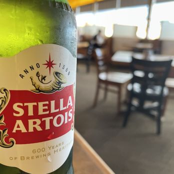 Timberline Restaurant - a hand holding a bottle of stella artois - American Near Me - Beaver, Utah Timberline Restaurant - a hand holding a bottle of stella artois - American Near Me - Beaver, Utah