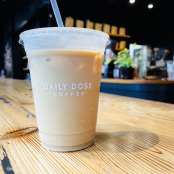 Daily Dose - Daily Dose Iced Vanilla Lavender Latte with counter in background. - Coffee & Tea Near Me - Atlanta, Georgia