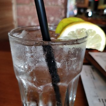 The Dime - a glass of water with a straw and a slice of lemon - Bars Near Me - Vancouver, British Columbia