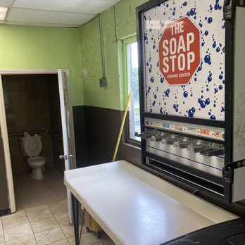 Super Coin Laundry - Laundry detergent vending machine hovers over folding table, located just outside of unisex bathroom. - Laundromat Near Me - Winston-Salem, North Carolina Super Coin Laundry - Laundry detergent vending machine hovers over folding table, located just outside of unisex bathroom. - Laundromat Near Me - Winston-Salem, North Carolina