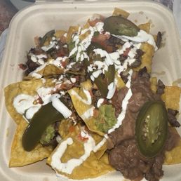 The trash Super Nachos I received with barely any toppings for $13 The trash Super Nachos I received with barely any toppings for $13