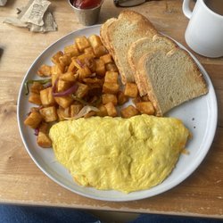 Ham and cheese omelet with sourdough and potatoes.