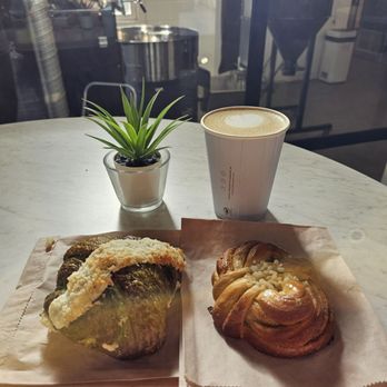 Eclipse Coffee Roasters - Pandan Coconut Croissant (Left), Cardamom Bun (Right), and Lavender Latte (Back) - Coffee & Tea Near Me - Canmore, Alberta