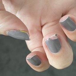 Horribly chipped nails a day and a half after manicure. My polish from my previous manicure is clearly showing on multiple fingernails.