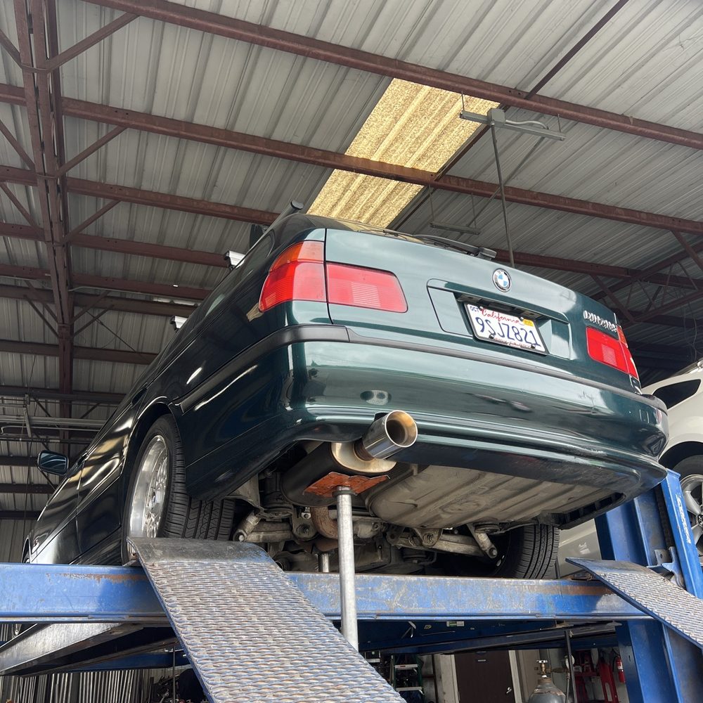 Our Dinan 5 Touring on the lift for a quick resonator replacement. Our Dinan 5 Touring on the lift for a quick resonator replacement.