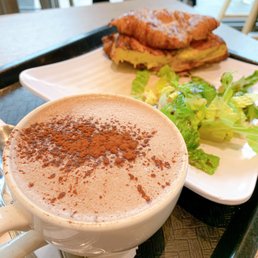 Egg and ham croissant sandwich with a hot chocolate. Egg and ham croissant sandwich with a hot chocolate.