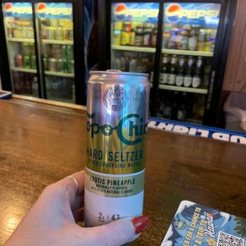 Bogey’s on Main - a person holding a can of beer - Pizza Near Me - Hinckley, Minnesota