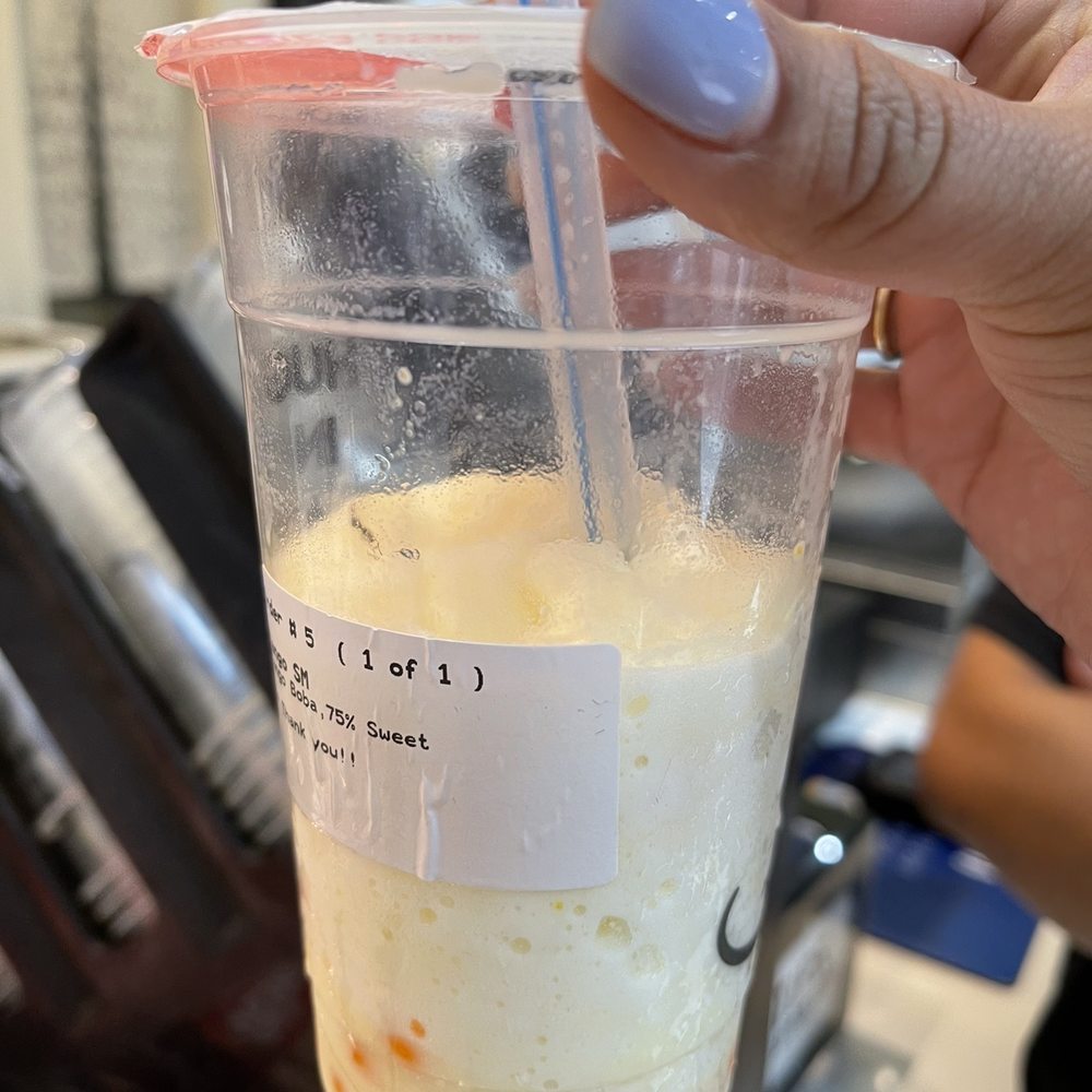 a hand holding a cup of iced coffee