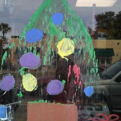 Historic Downtown - Tree painted on the hardware window store at Christmas.