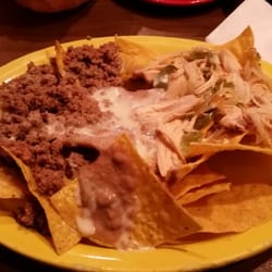 El Bigotes Mexican Grill - Nachos supreme.  Beef, chicken (with peppers & onions), refried beans with lettuce, tomato, sour cream, guacamole on the side.