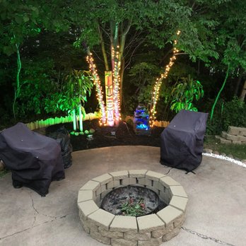 Bremen Woods Resort - The island theme: Our firepit area with lit up trees and totem pole. - Campgrounds Near Me - Willow River, Minnesota