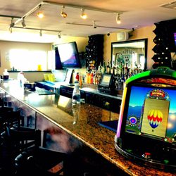 Tin Cup's Caddyshack - Full Service Bar & 5 big Screen TV's.   Come in, and if your game is not on, just ask and you shall receive.