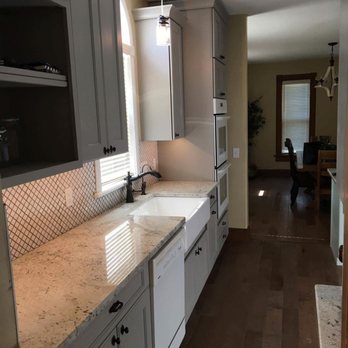 Ex Cat Construction - a kitchen with white cabinets and granite countertops - General Contractors Near Me - Newton, Kansas Ex Cat Construction - a kitchen with white cabinets and granite countertops - General Contractors Near Me - Newton, Kansas
