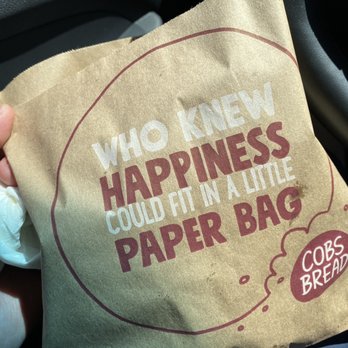 Cobs Bread - a person holding a paper bag with the words who knew happiness could fit in a little paper bag - Bakeries Near Me - Edmonton, Alberta