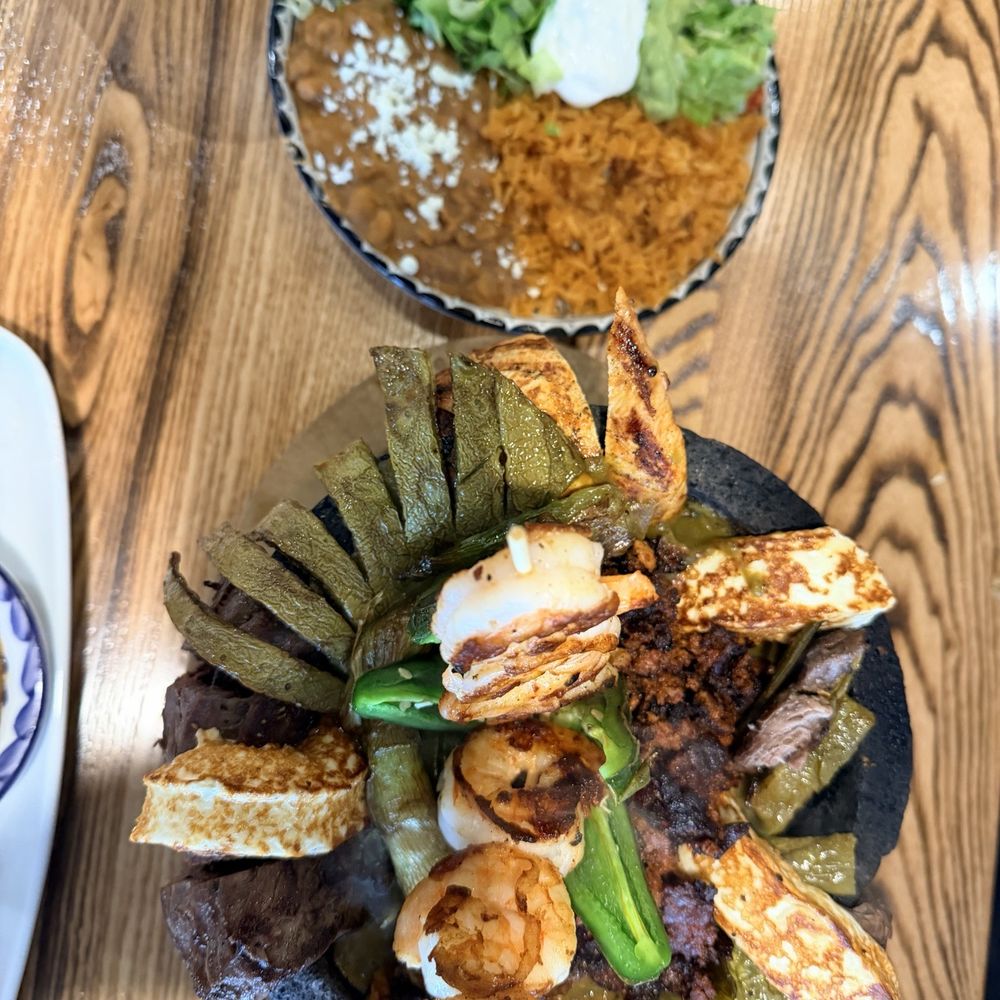 Molcajete: steak, chicken, shrimp, chorizo, Queso fresco, grilled cactus, onions and tomatillo salsa. Molcajete: steak, chicken, shrimp, chorizo, Queso fresco, grilled cactus, onions and tomatillo salsa.