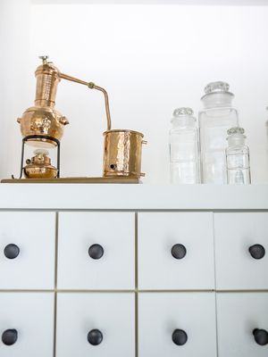 Photo of Wildwood Spirits - Bothell, WA, US. a copper coffee grinder on top of a dresser