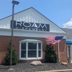 ROAM Dispensary - ROAM Dispensary Medical and Adult Use Recreational Dispensary Outside of the building to the left, shine on sign
