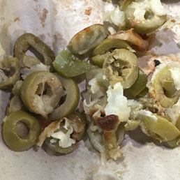 This is the pile of olives off four pieces of pizza. This is the pile of olives off four pieces of pizza.