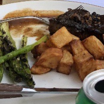 Toscana - Steak with crispy potatoes and asparagus. - Italian Near Me - Charlotte, North Carolina Toscana - Steak with crispy potatoes and asparagus. - Italian Near Me - Charlotte, North Carolina