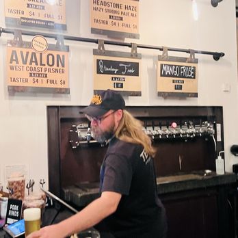 Ten Mile Brewing - Taps at the counter with signs above and VATs in the background - Breweries Near Me - Signal Hill, California
