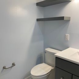 Finished toilet, vanity, and shelves Finished toilet, vanity, and shelves
