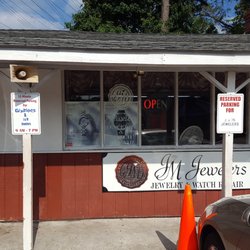J & M Jewelers - Front door is to the left of the sign.