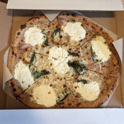 Blanca pizza - green garlic, red onion, cream, basil, mozzarella, cheddar, and ricotta