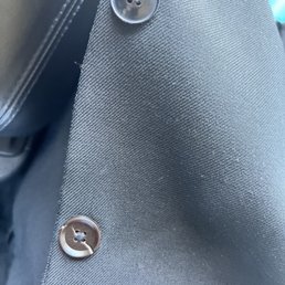 She put 1 black and 1 brown button with a white streak on it. Total joke!