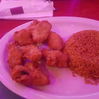 Abuja International Restaurant - Chicken wings and jallof. Not on the menu as a dinner plate but my waitress made it happen - African Near Me - Union, New Jersey