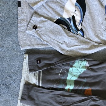 Rainbow Cleaners - Logo moved from lower back of shirt (normal placement shown on dark gray shirt) to sleeve to patch the hole on the light gray shirt! - Sewing & Alterations Near Me - Manhattan Beach, California
