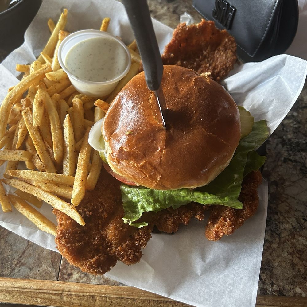 Sixth Street Dive - Breaded tenderloin sandwich with lettuce tomatoes onions and pickles - Tex-Mex Near Me - Lafayette, Indiana Sixth Street Dive - Breaded tenderloin sandwich with lettuce tomatoes onions and pickles - Tex-Mex Near Me - Lafayette, Indiana