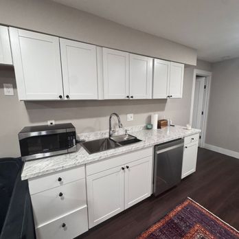Cosmo Builders - New basement kitchenette with quartz counters and modern lighting. - General Contractors Near Me - McLean, Virginia Cosmo Builders - New basement kitchenette with quartz counters and modern lighting. - General Contractors Near Me - McLean, Virginia