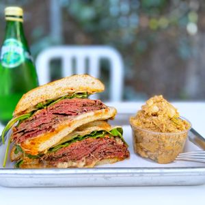 Photo of HOT JOHNNIE’S - San Francisco, CA, United States. Acme Pain de Mie w/ smoked pastrami, spicy chipotle aioli, pickles, arugula, sub cheddar for havarti ($18.50), Potato Salad ($3)