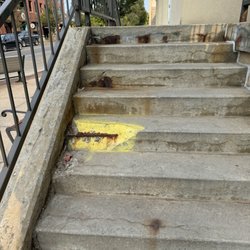 Park Place Hotel - Large piece of cement missing from stairs going into hotel.