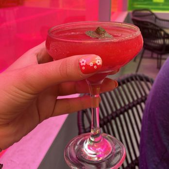 Cibar - a hand holding a wine glass with a red drink in it - Lounges Near Me - New York, New York Cibar - a hand holding a wine glass with a red drink in it - Lounges Near Me - New York, New York