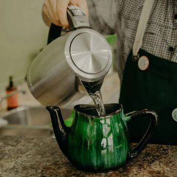 Thésaurus Thérrarium - a person pouring water into a teapot - Tea Rooms Near Me - Montreal, Quebec Thésaurus Thérrarium - a person pouring water into a teapot - Tea Rooms Near Me - Montreal, Quebec