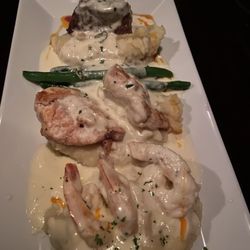 3 Brothers Plate Steak, chicken and shrimp with mashed potatoes underneath and asparagus