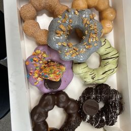 Cinnamon sugar, glazed, black sesame, ube fruity pebbles, matcha, chocolate, and cookies and cream mochi donuts.