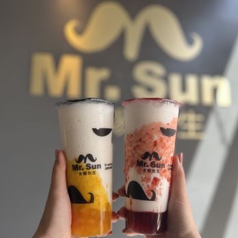 Mr Sun Tea - a hand holding two cups of tea - Bubble Tea Near Me - Sacramento, California