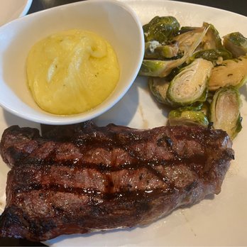 110 Grill - New York strip cooked medium well with brussel sprouts and garlic mashed potatoes - New American Near Me - West Lebanon, New Hampshire