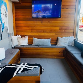 Gravity Coffee - a couch with pillows and a flat screen tv - Coffee & Tea Near Me - Lakewood, Washington Gravity Coffee - a couch with pillows and a flat screen tv - Coffee & Tea Near Me - Lakewood, Washington