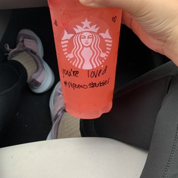 Starbucks - a hand holding a cup of drink - Coffee & Tea Near Me - Nipomo, California
