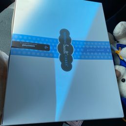 a white box with a blue ribbon a white box with a blue ribbon