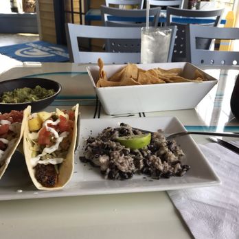 Surf House - I got the blacked Mahi Mahi fish tacos w/black beans and rice, fresh guac and chip (they were nice and hot) My sangria drink was tasty - New American Near Me - Frederick, Maryland