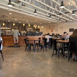people sitting at tables in a coffee shop people sitting at tables in a coffee shop