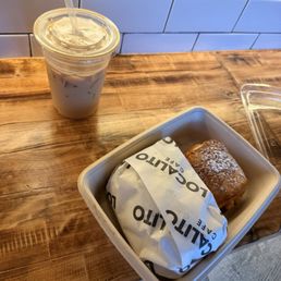 Iced latte, guava and cheese pastry and breakfast sandwich on a croissant Iced latte, guava and cheese pastry and breakfast sandwich on a croissant