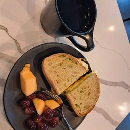 Breakfast sandwich with avocado, cup of the Winter blend