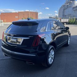 Elite Luxury Transports - Rear view of our Cadillac XT5, professionally maintained for comfortable, prearranged airport transportation.