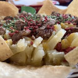 El Tejano - Baked potato with bacon bits cheese and chives topped with molleja.