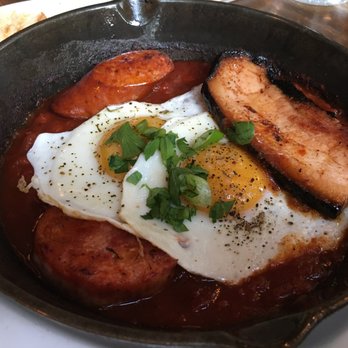 Medina Cafe - cassoulet: 2 sunny eggs, smoked bacon, andouille sausage, saucisson de Paris, white beans, red wine, roma tomatoes + grilled focaccia = $17 - Breakfast & Brunch Near Me - Vancouver, British Columbia Medina Cafe - cassoulet: 2 sunny eggs, smoked bacon, andouille sausage, saucisson de Paris, white beans, red wine, roma tomatoes + grilled focaccia = $17 - Breakfast & Brunch Near Me - Vancouver, British Columbia